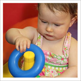 Young toddler playing with toy