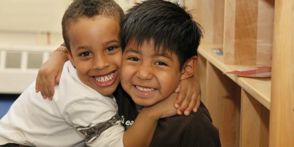 two young boys hugging