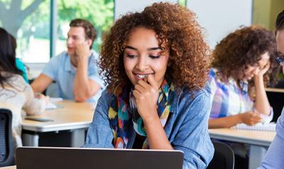 Young teacher looking at a computer screen