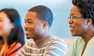 Four diverse professionals smiling ahead