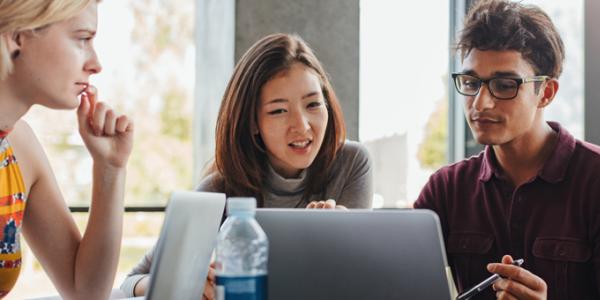 College students gathered around a computer screen