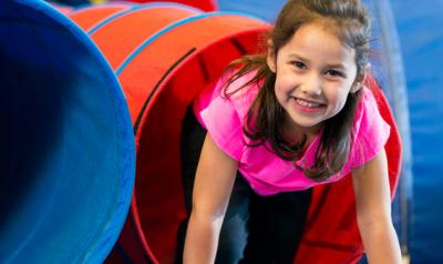 Little girl playing in a tent