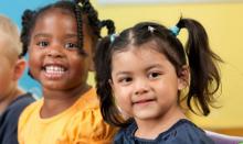 Diverse group of children in a classroom.