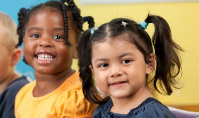 Group of five diverse children smiling