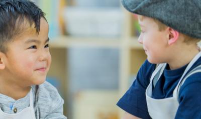 Two boys smiling in class