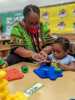 cashawn thompson guiding a child through play