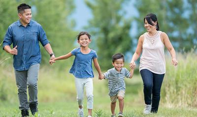 family of four walking oputdoors