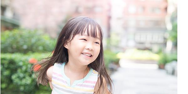 Preschool girl smiling outside