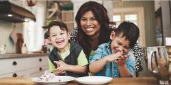 Mother and two sons playing in the kitchen