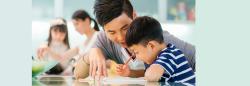 Father helping child with drawing