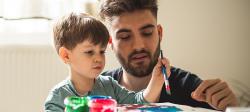 a parent painting with a child