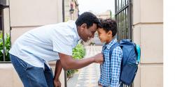 Father and son saying goodbye outside of school