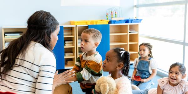 Teacher talking calmly with a young child