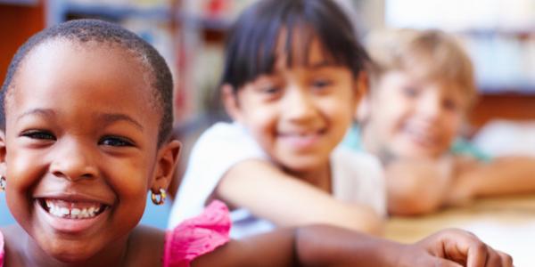 Children sitting at a table in the library