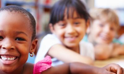 Children sitting at a table in the library