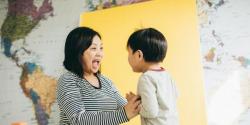 A mother sings and plays with her son