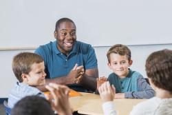 Teacher interacting with his three students.