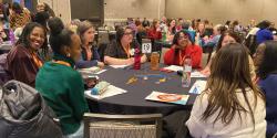 conference attendees discussing something at a table