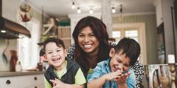 mother hugging two sons in the kitchen