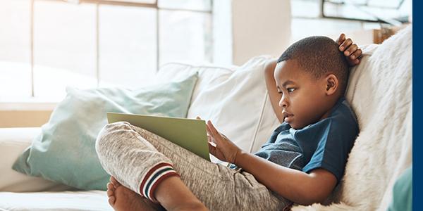 Child reading a book at home