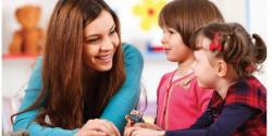 Two young children talk to an adult