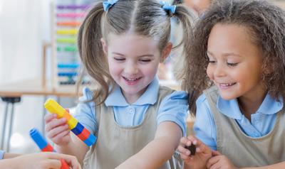 Children building with colored cubes.