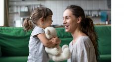 Mother and and a little girl holding a teddy bear