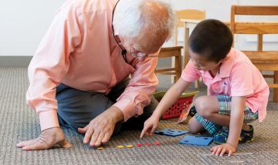 Teacher playing math game with child