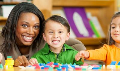 Teacher and preschooler counting blocks