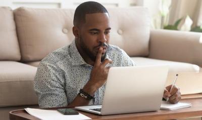 man at a laptop reading the screen