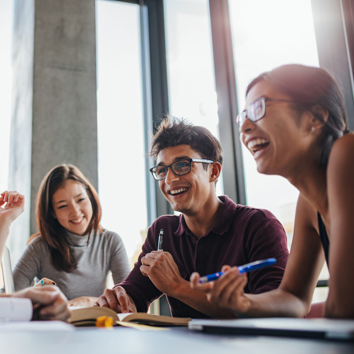 Three higher education students studying