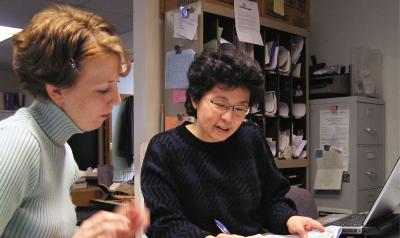 Two women looking at paperwork together