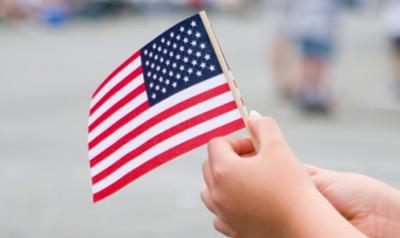 a child holding an American flag