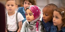 a group of young children focusing on a discussion