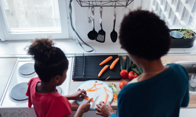 a parent and child cooking together