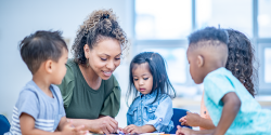 a teacher engaged in a project with young children