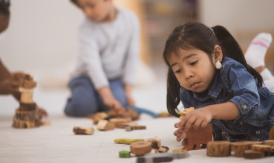 A child playing with blocks on the floor.