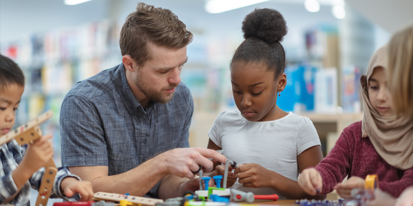 a teacher making crafts with a child