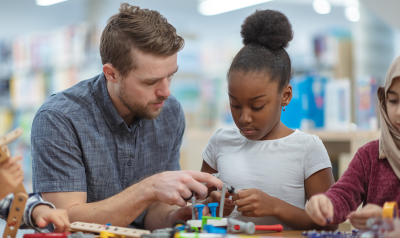 a teacher making crafts with a child