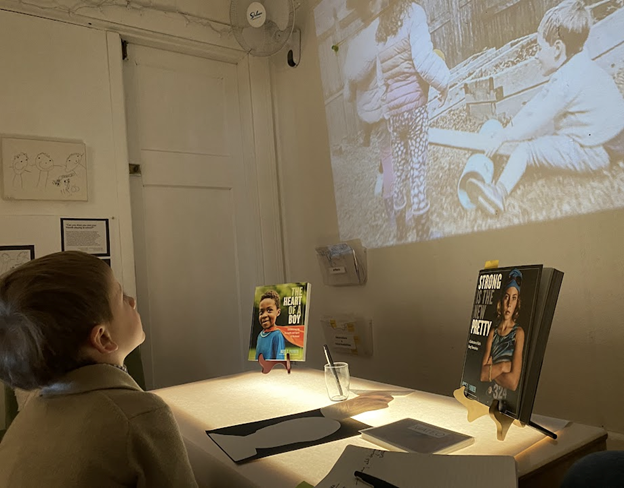 a child watching a film projected on a screen