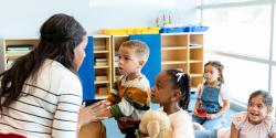 A teacher talking to a group of students.