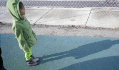 Girl looking at her shadow