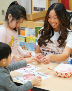 A teacher guides children in a small-group activity.