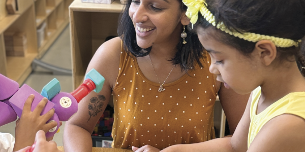 a teacher playing with toys with children